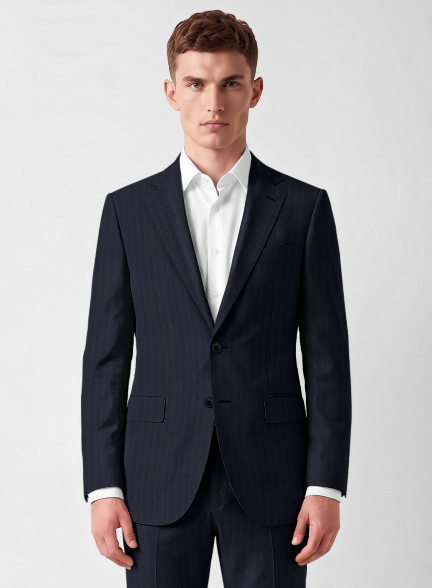 Man wearing a navy blue herringbone wool jacket with notch lapel and flap pockets