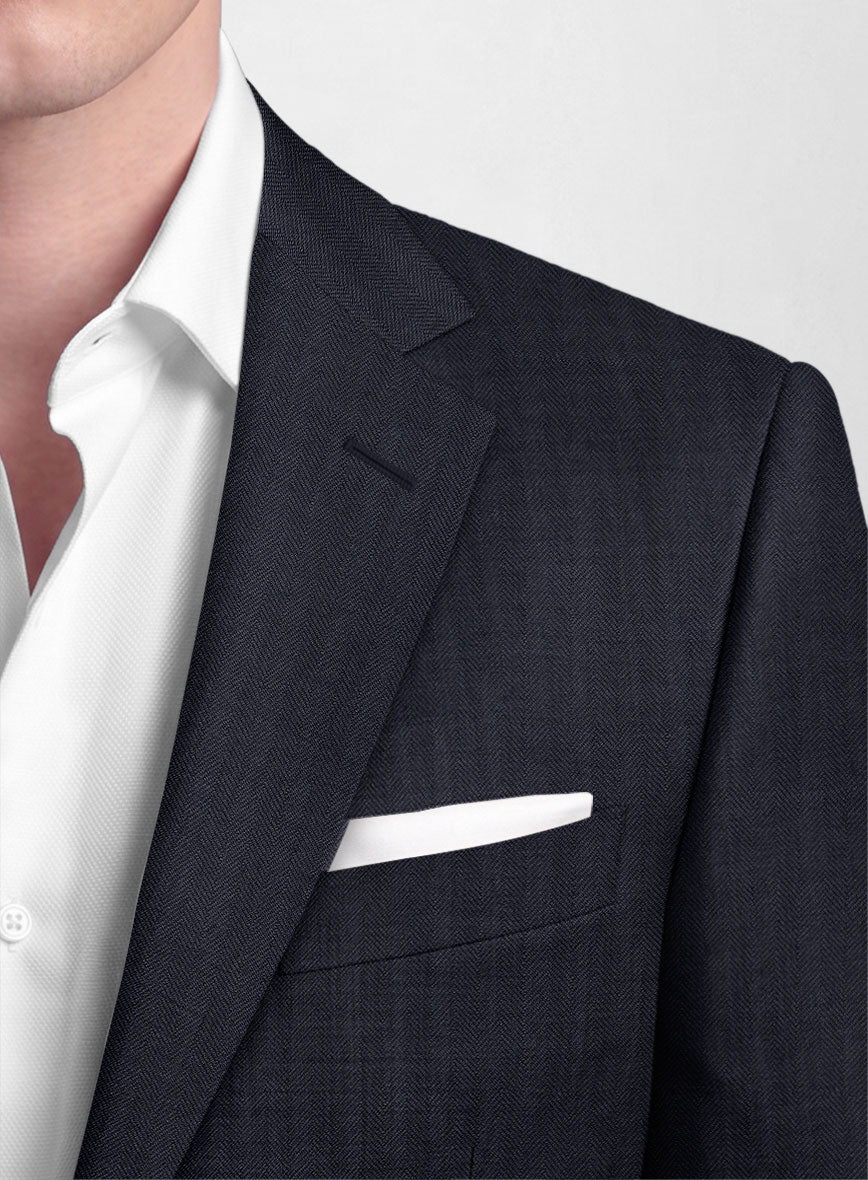 Close-up of navy blue herringbone wool suit lapel and chest pocket with white pocket square