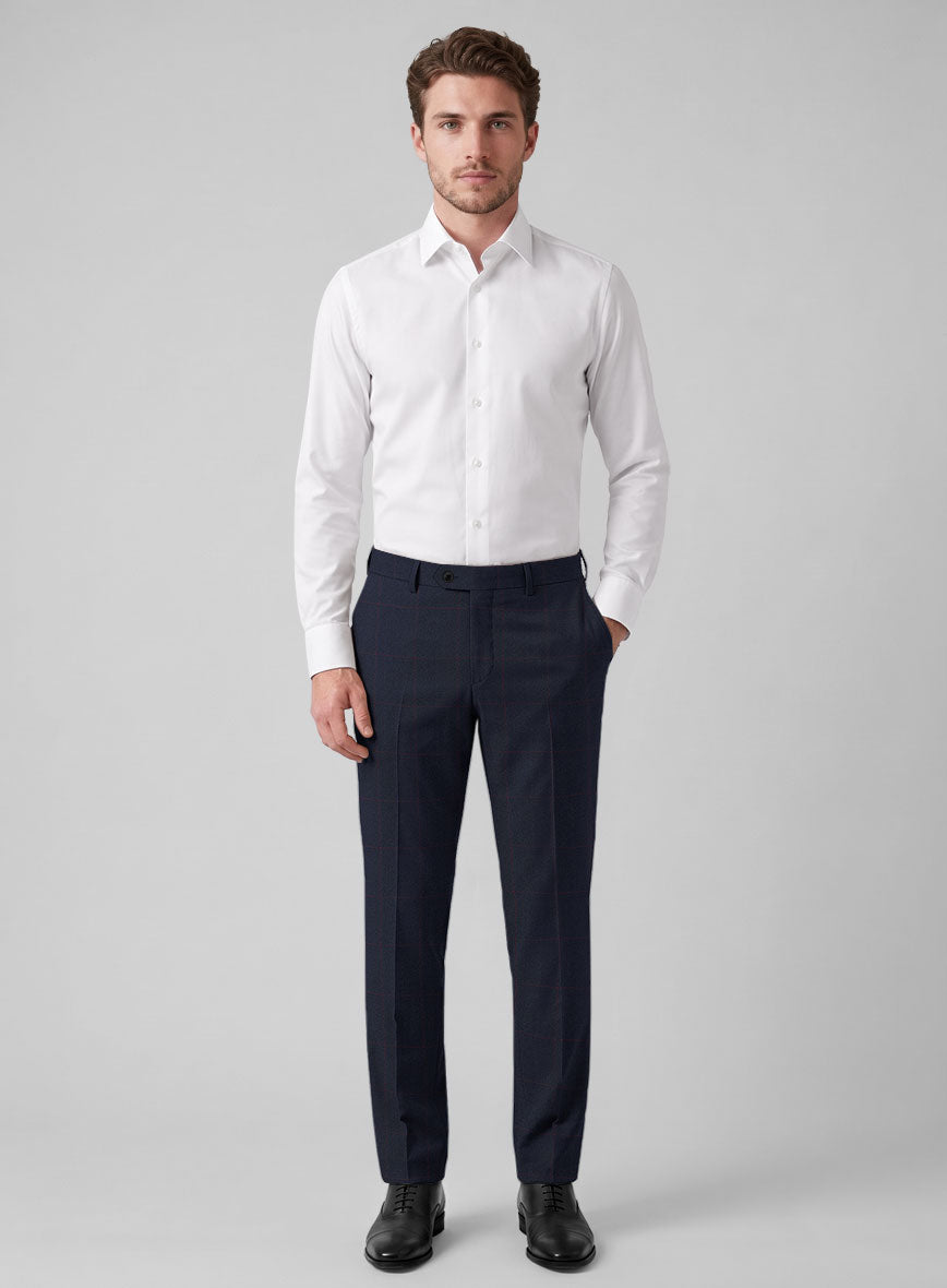 Man wearing navy blue windowpane wool trousers with a white shirt and black oxford shoes, front view