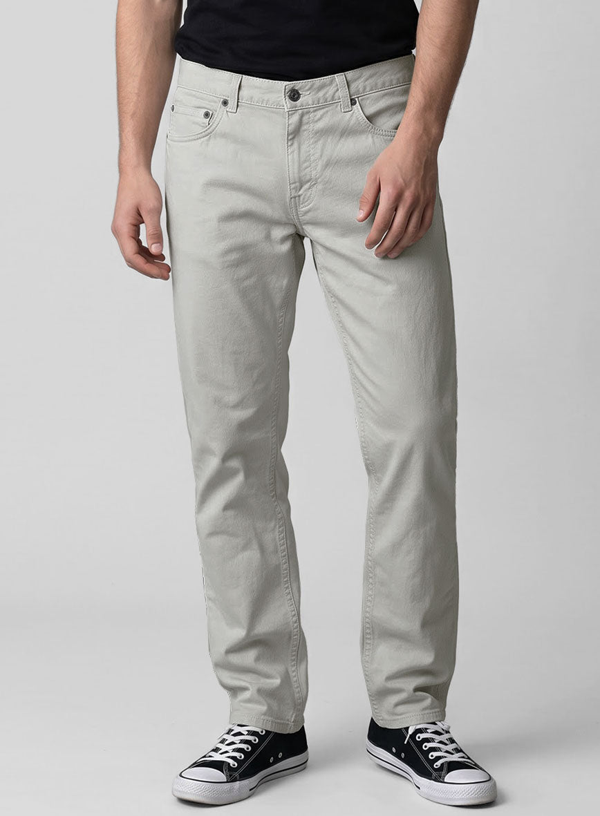 Front view of light gray stretch chino jeans with five-pocket styling on a model