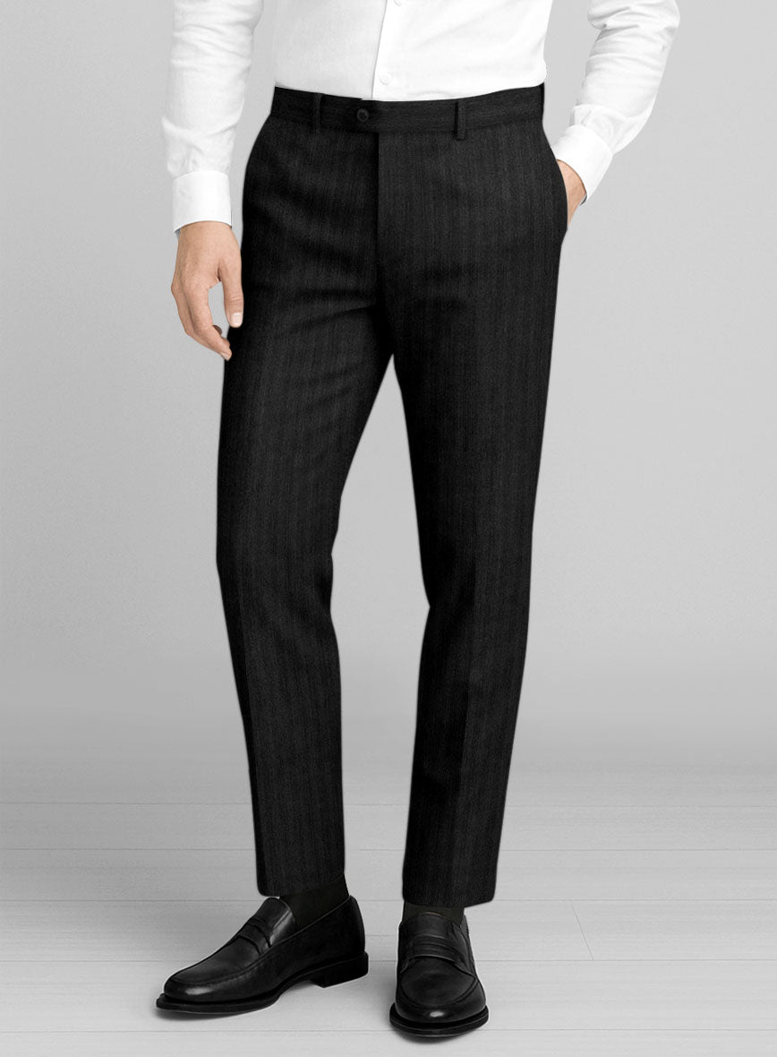 Front view of black herringbone wool trousers on a model with black loafers