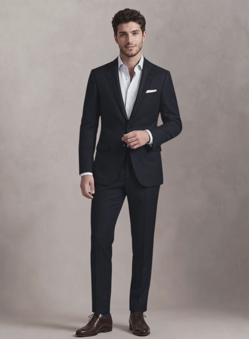 Man wearing a dark navy wool suit with white shirt and brown oxford shoes