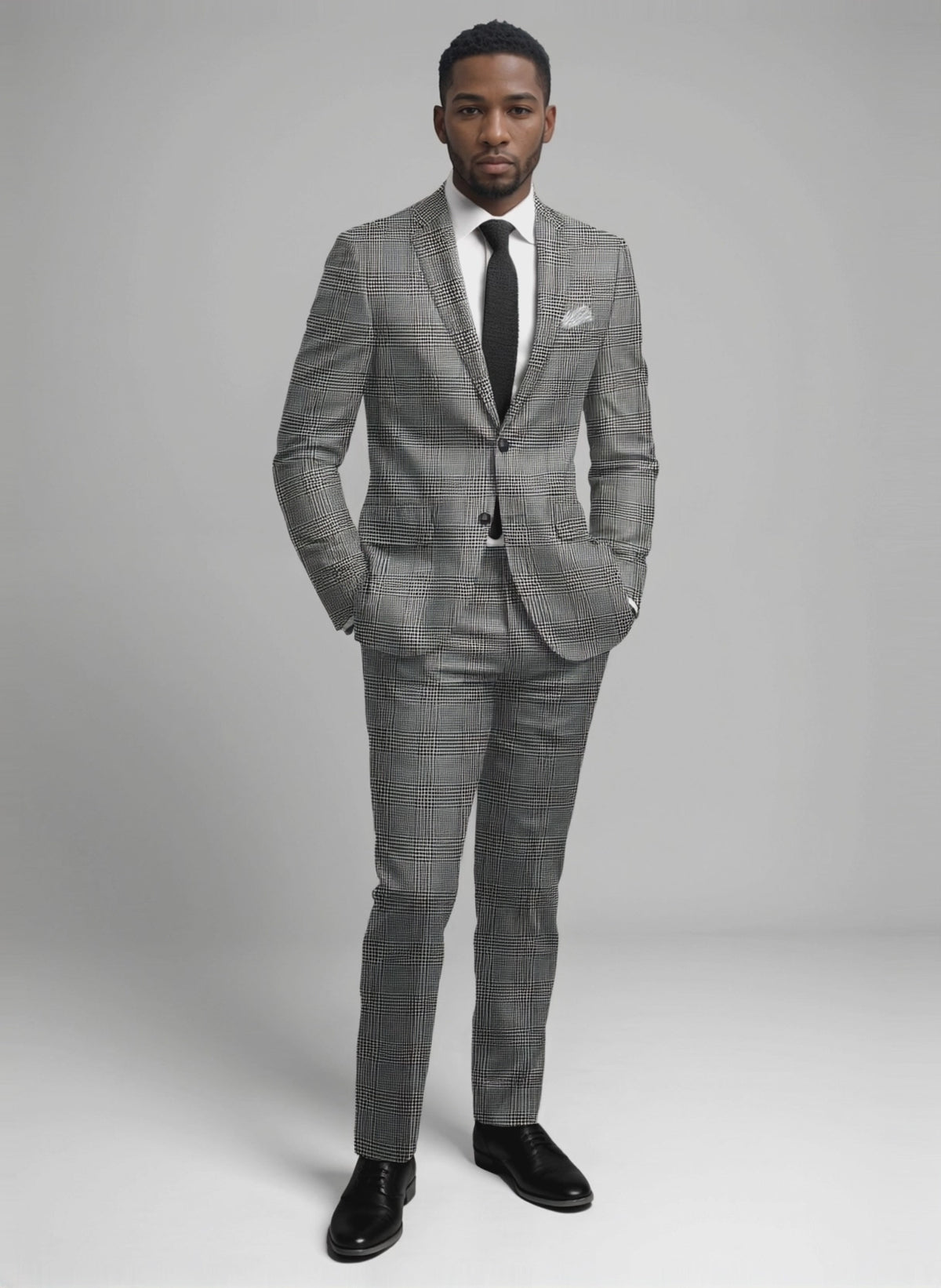 Man wearing a black and white wool jersey suit in a bold glen check pattern