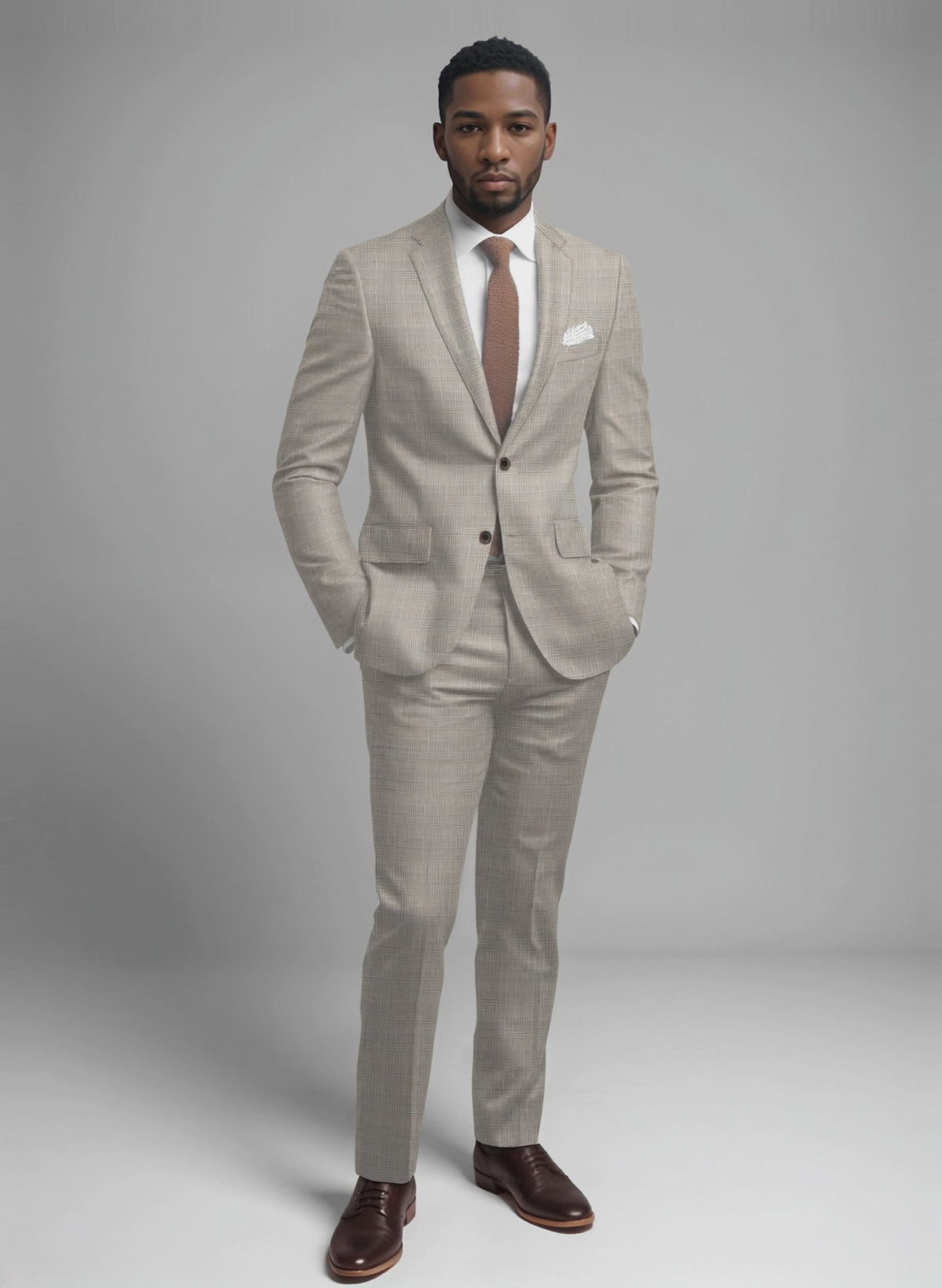 Man wearing a beige Prince of Wales check suit with a rust knit tie