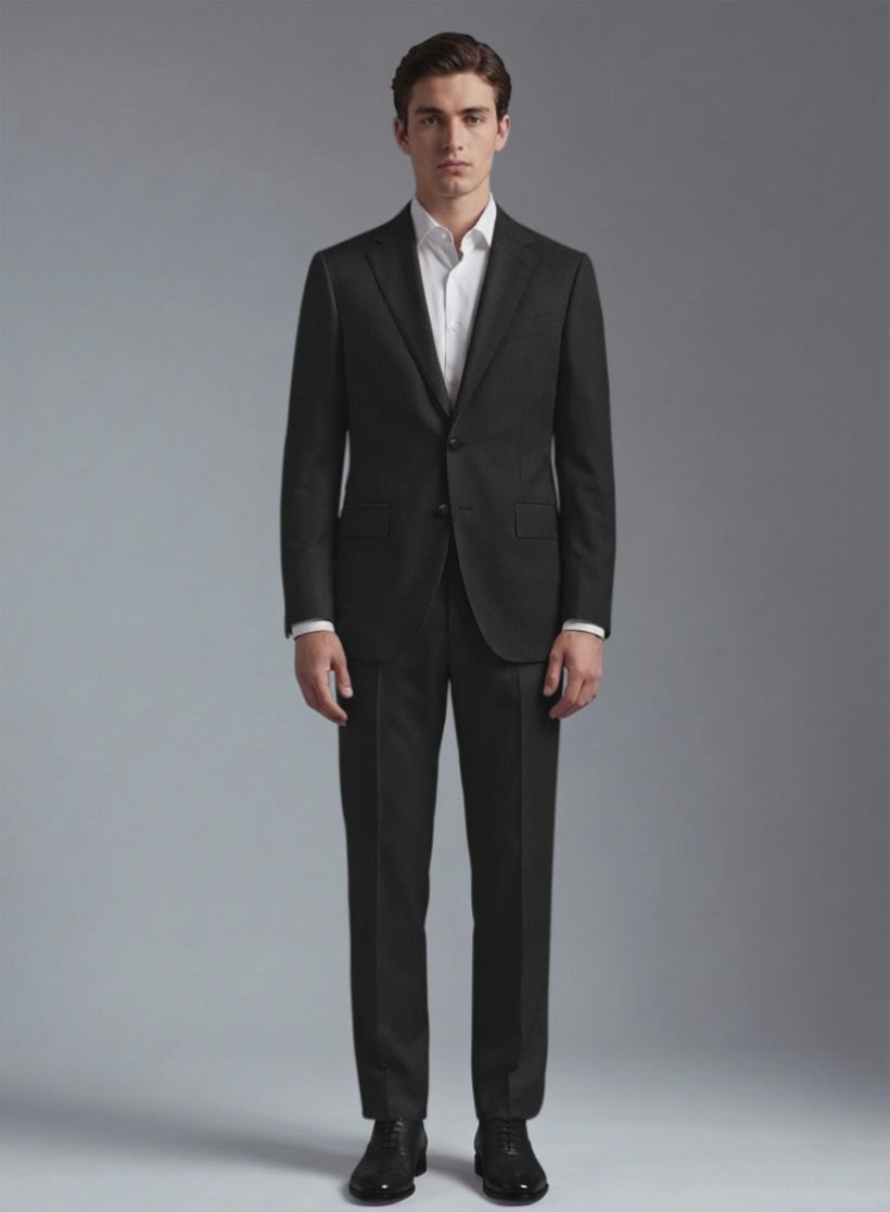 Man wearing a black wool suit with notch lapel and white shirt, front view