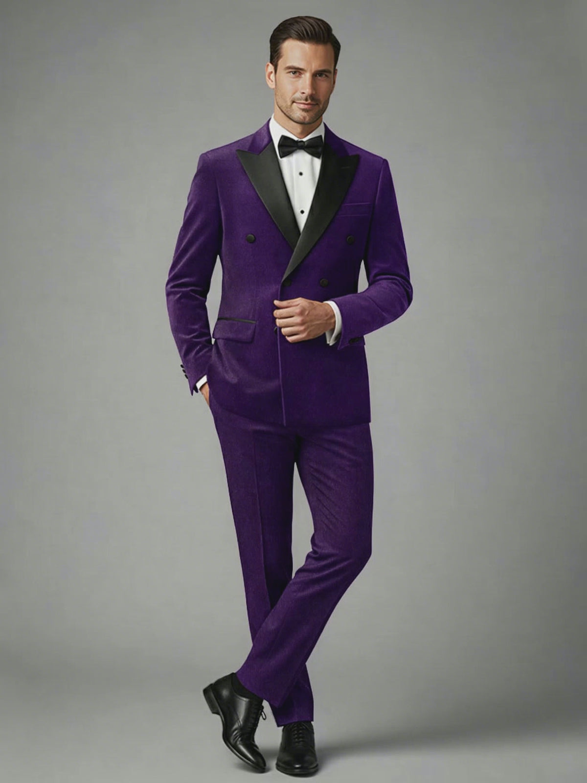 Man wearing a purple velvet double-breasted tuxedo suit with black peak lapels and bow tie