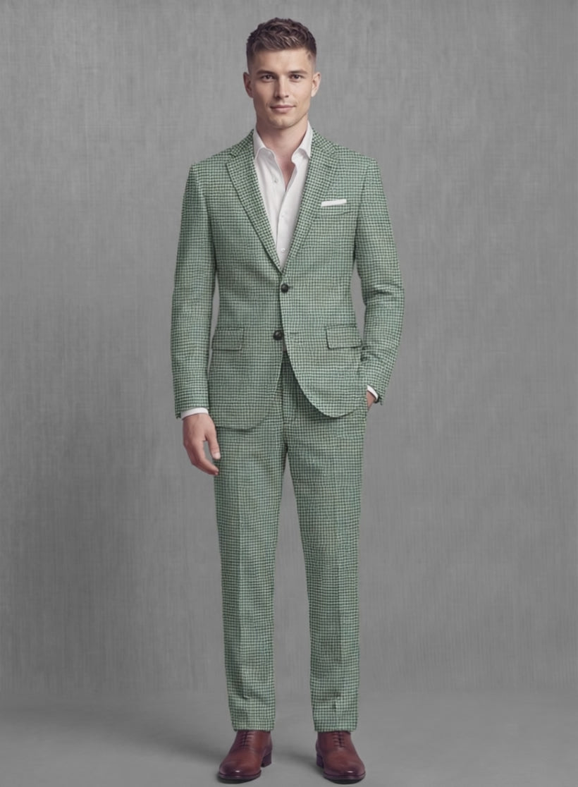 Man wearing a moss green houndstooth soft tweed suit, front view with hand in pocket