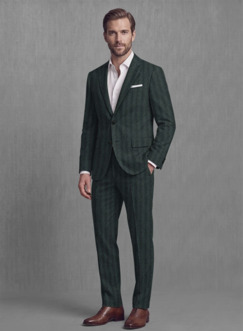 Man wearing a dark olive green striped soft tweed suit with white pocket square