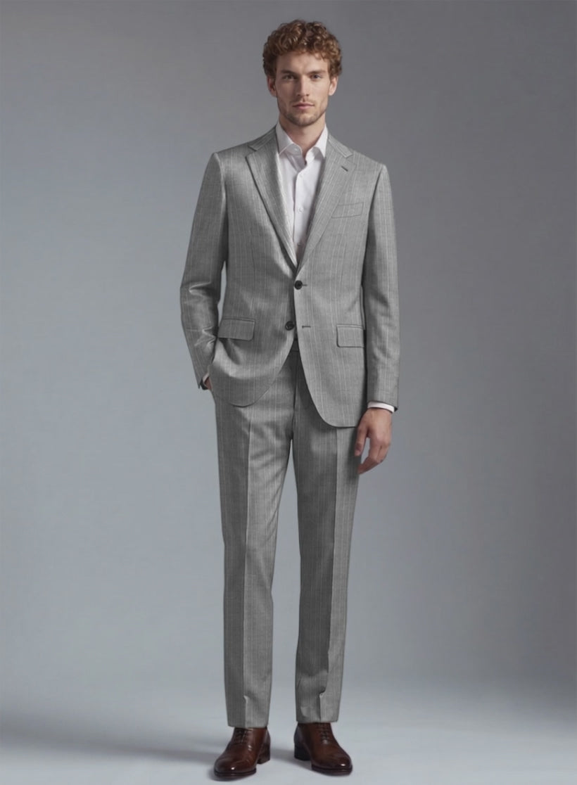 Man wearing a grey wool gessato pinstripe suit, two-button jacket with flap pockets