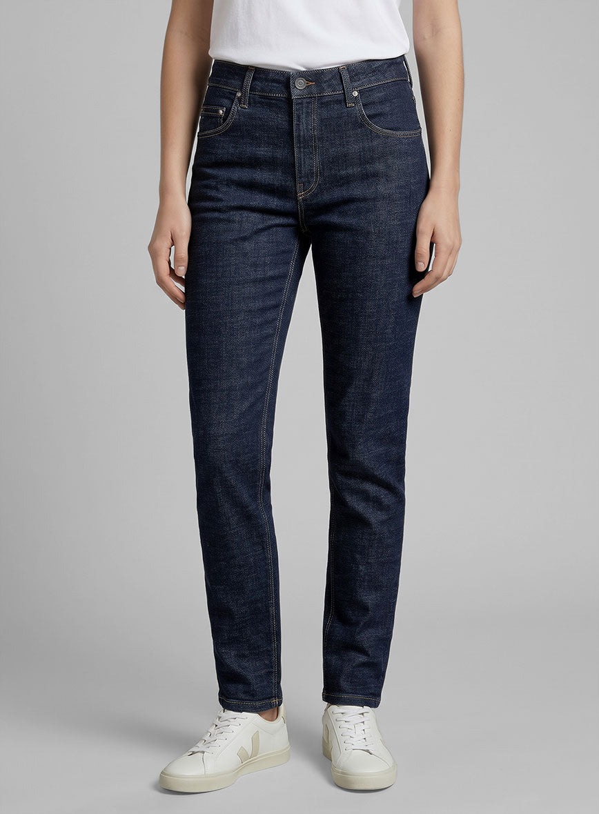 Front view of women's indigo stretch denim jeans worn with a white t-shirt and sneakers