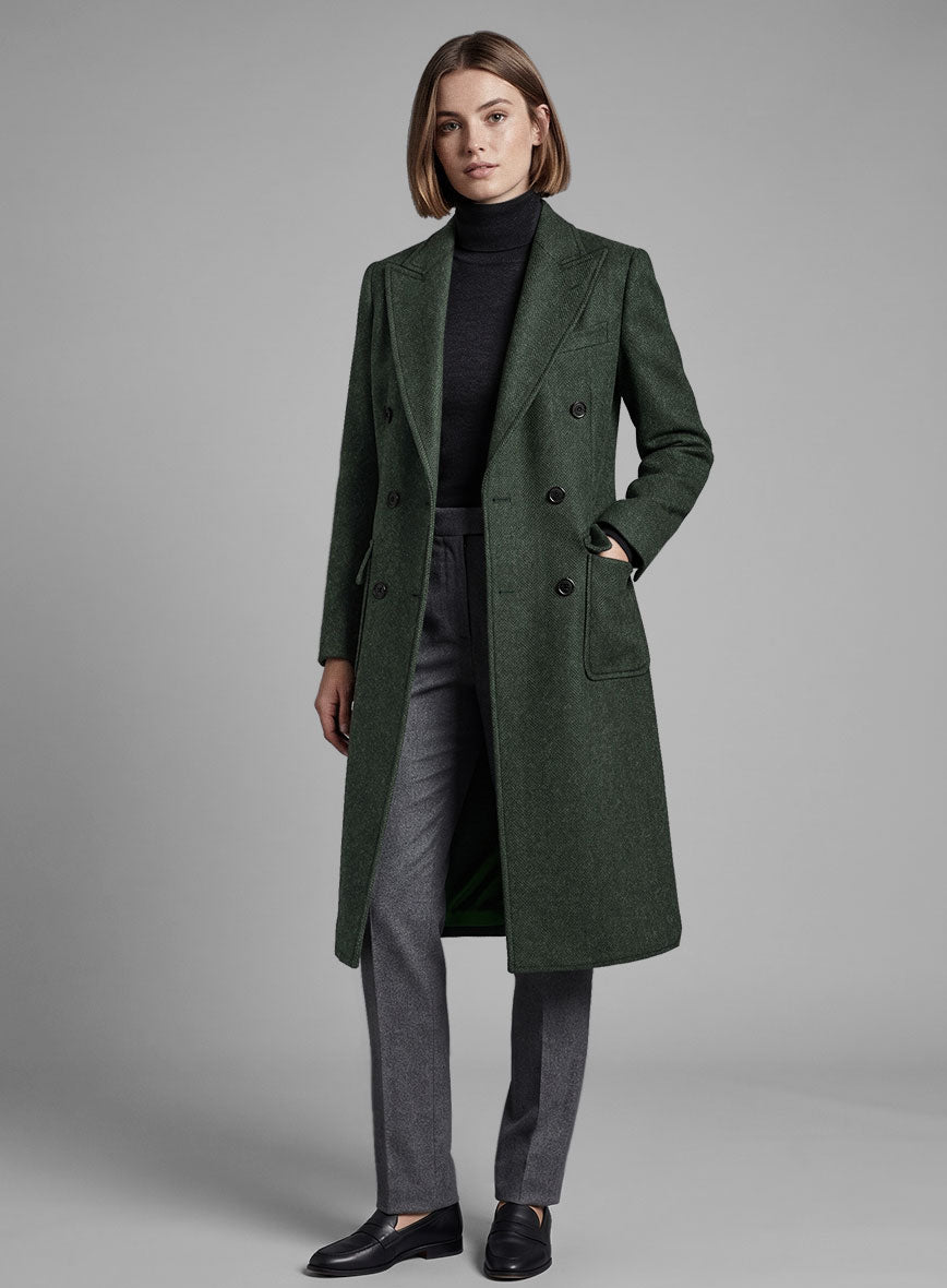 Full-length view of a woman wearing a green heavy tweed overcoat with grey trousers